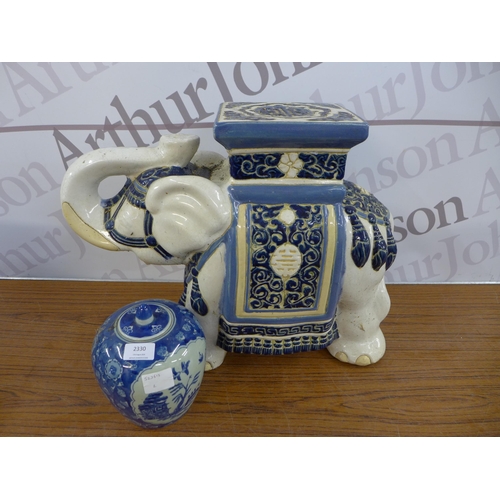 2330 - A Chinese blue and white urn marked with Chinese markings to base with a Chinese style elephant stan... 