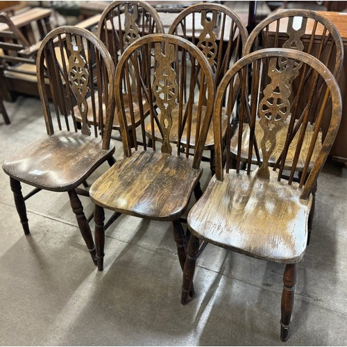 208 - A set of six elm and beech wheel back kitchen chairs