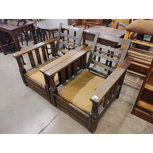 174 - A pair of early 20th Century oak reclining armchairs