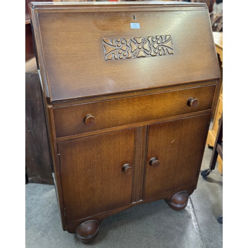 215 - An early 20th Century carved oak bureau