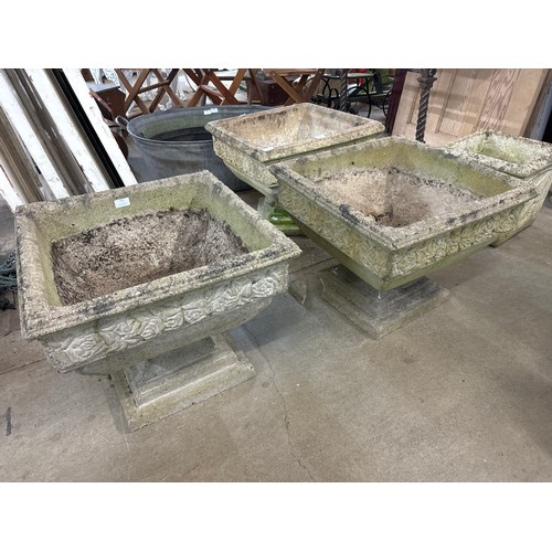 252 - A pair of square concrete garden planters on stands