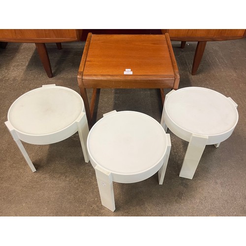 95 - A small teak side table and three Dutch plastic nesting tables