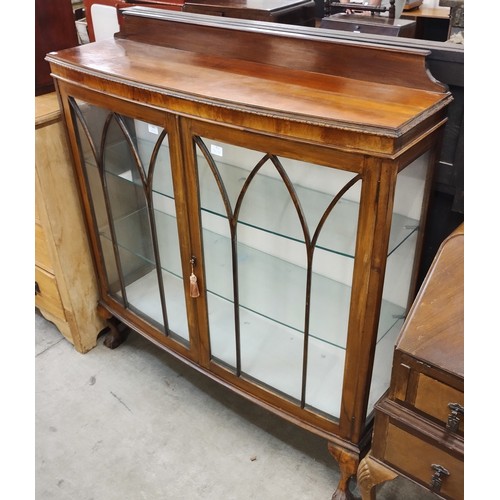 182 - An early 20th Century walnut bow front display cabinet