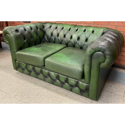 104 - A green leather Chesterfield sofa