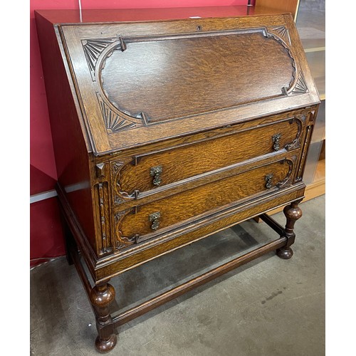 110 - An early 20th Century carved oak cantilever action bureau