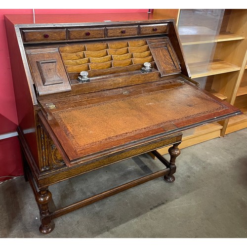 110 - An early 20th Century carved oak cantilever action bureau