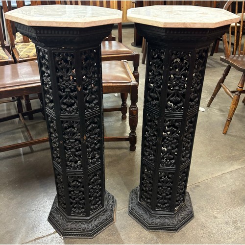 261 - A pair of Victorian style filigree pattern octagonal cast iron and marble topped jardiniere stands