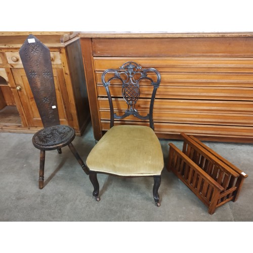 194 - A Victorian carved mahogany lady's chair, a carved beech spinning stool and an oak newspaper stand