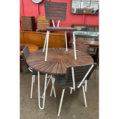 262D - A Danish Daneline teak and white tubular metal sunburst garden table and four chairs