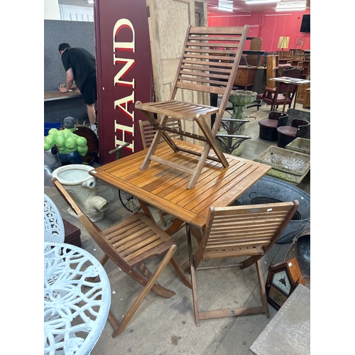 277 - A teak folding garden table and four chairs