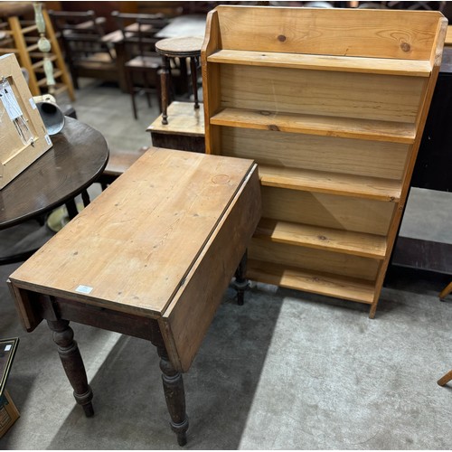 242 - A Victorian pine drop leaf kitchen table and a pine open bookcase