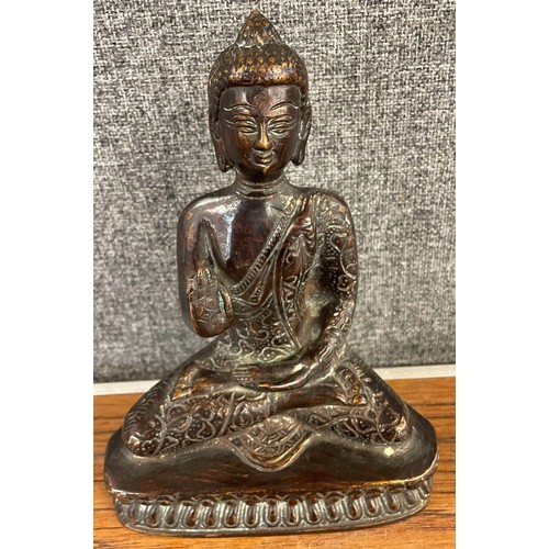 369 - A 19th Century style oriental bronze figure of a seated deity