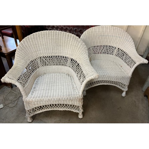 246 - A pair of painted wicker armchairs