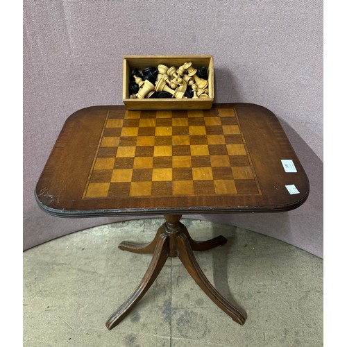 340 - An early 20th Century carved wood chess set and a games table