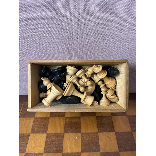 340 - An early 20th Century carved wood chess set and a games table