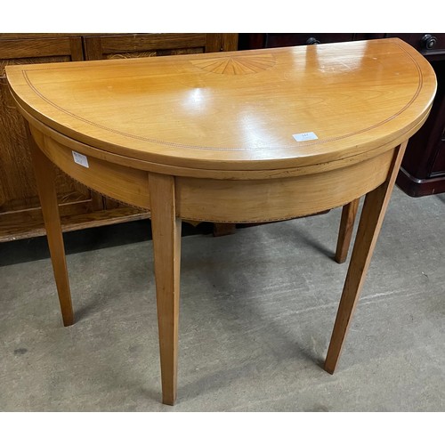 147 - A George IV mahogany and satinwood inlaid demi-lune fold over tea table