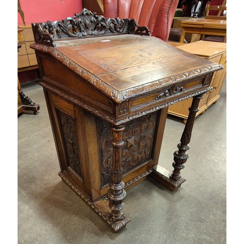 115 - A Victorian Jacobean Revival carved oak Davenport