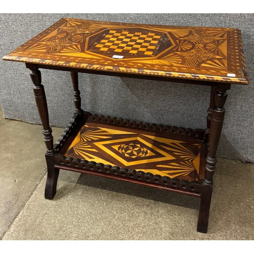 101 - A Victorian marquetry inlaid mahogany and walnut games table