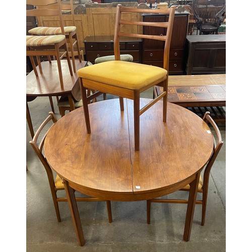 44 - A teak circular extending dining table and three Meredew dining chairs