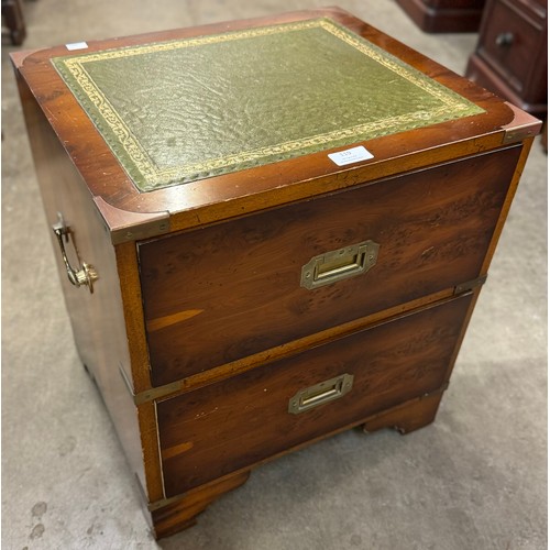 119 - A small campaign style yew wood and green leather topped chest of drawers