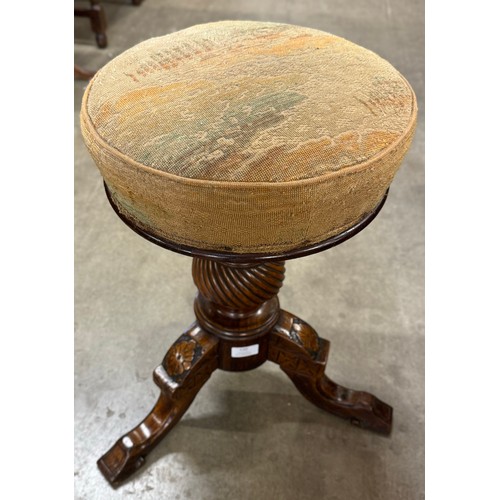 120 - A Victorian carved walnut piano stool