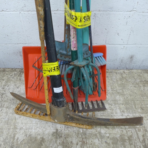 2158 - A quantity of garden tools including a pick axe, rakes, lawn aerator, brushes, etc.