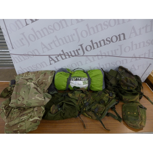 2239 - A Vango NYX200 tent and a quantity of army clothing including coats, boots, vests, etc.