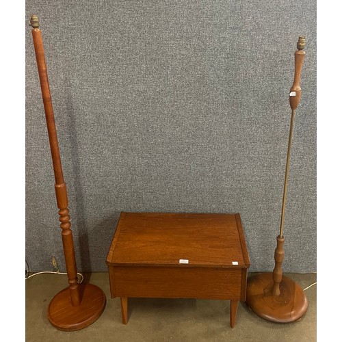 58 - Two teak standard lamps and a lady's teak sewing box