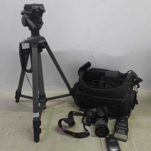 2057 - A Sony DSLR-A100 camera, a Sony HVL-F42AM camera flash, a Cullmann camera tripod and other camera eq... 