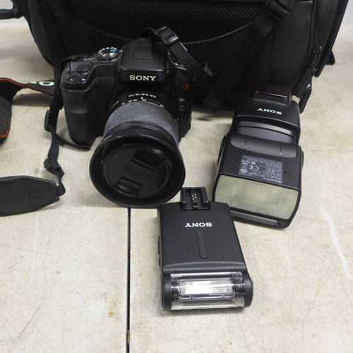 2057 - A Sony DSLR-A100 camera, a Sony HVL-F42AM camera flash, a Cullmann camera tripod and other camera eq... 