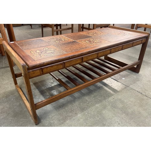 55 - A teak and Formica sleigh topped coffee table and a teak and tiled top coffee table