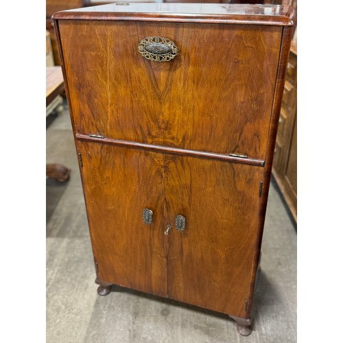 129 - An early 20th Century walnut cocktail cabinet