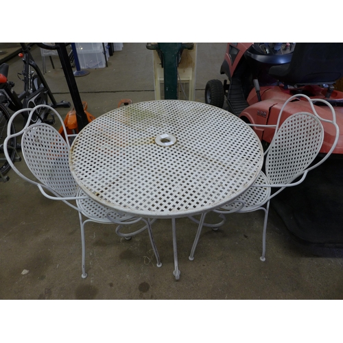 2114 - A circular metal patio table and 2 metal patio chairs