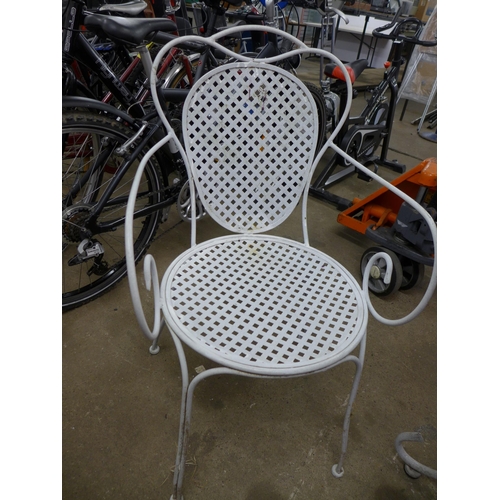 2114 - A circular metal patio table and 2 metal patio chairs