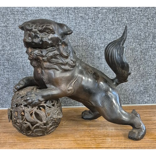 344 - An oriental cast iron figure of dog of foe