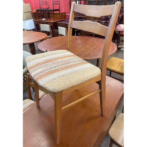 76 - A teak drop leaf table and four chairs