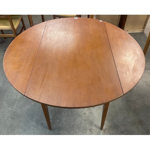 76 - A teak drop leaf table and four chairs