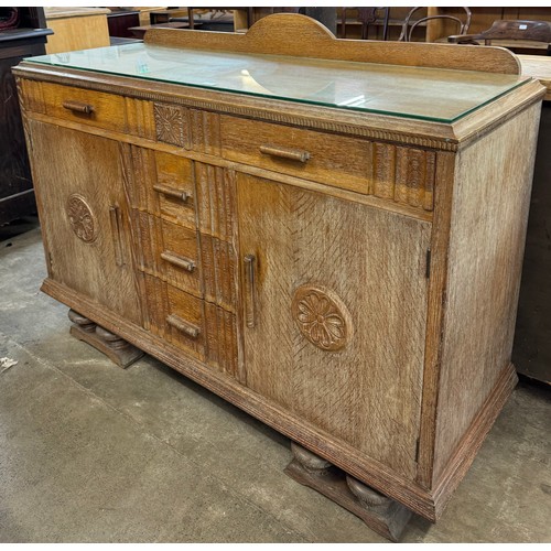 171 - An early 20th Century carved oak sideboard