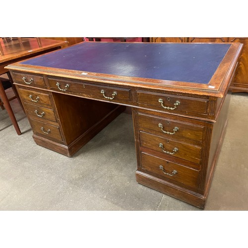 88 - A Victorian mahogany and blue leather topped pedestal desk