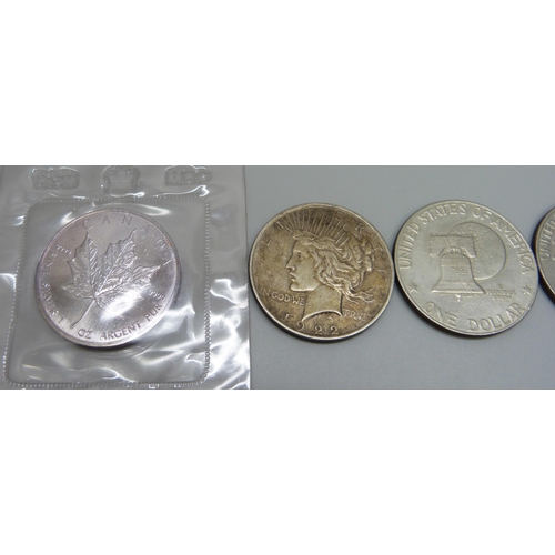 1047 - A 1922 silver dollar, a 1989 Maple Leaf 1oz silver coin, (pure), sealed mint pack, and four Eisenhow... 