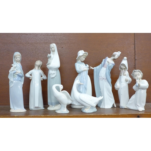 604 - Nine Lladro, Nao and Spanish style figures including flapper girl, girl with cat and girl with dog