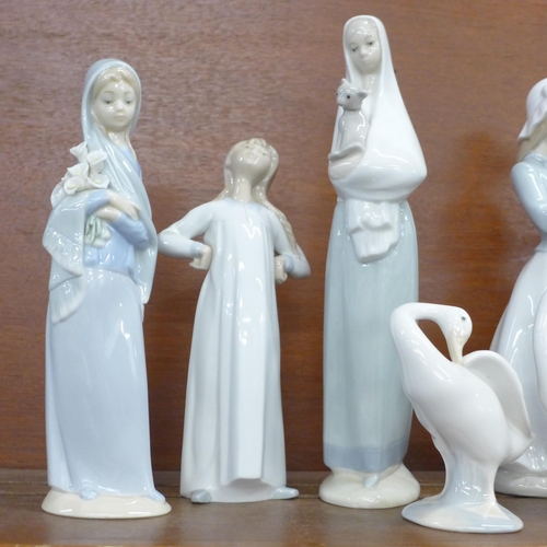 604 - Nine Lladro, Nao and Spanish style figures including flapper girl, girl with cat and girl with dog