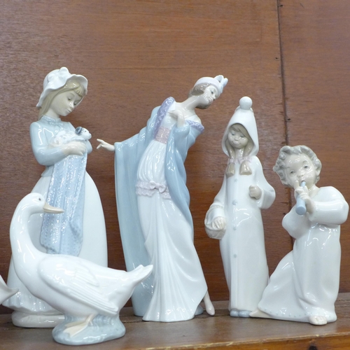 604 - Nine Lladro, Nao and Spanish style figures including flapper girl, girl with cat and girl with dog