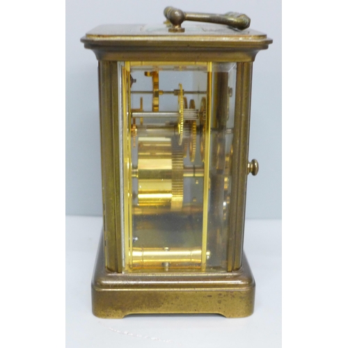 613 - A Matthew Norman brass and four glass sided clock, with key