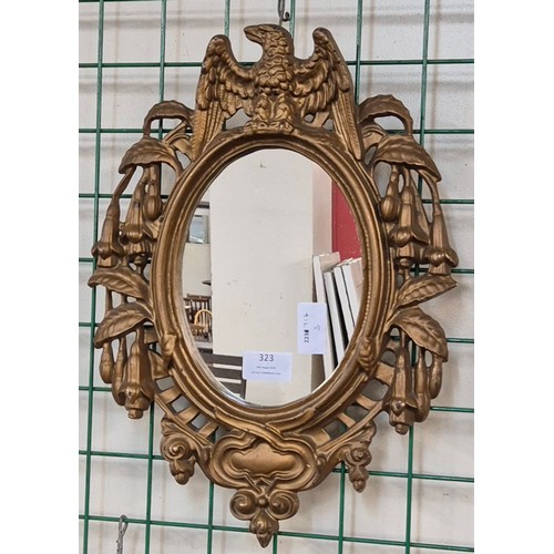 323 - A small Victorian style cast iron gilt framed mirror