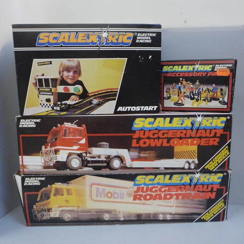 722 - Scalextric; two Juggernaut roadtrains, C301, C302, an autostart and accessory pack, all boxed