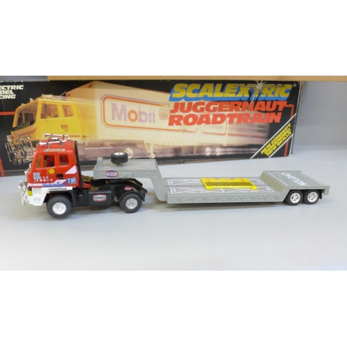 722 - Scalextric; two Juggernaut roadtrains, C301, C302, an autostart and accessory pack, all boxed