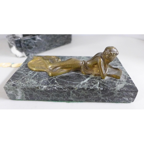 773 - A bronze study of a lady in gown, reclining and reading a book, mounted on a green marble base, chip... 