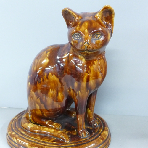 787 - A treacle glaze model of a cat, 30cm