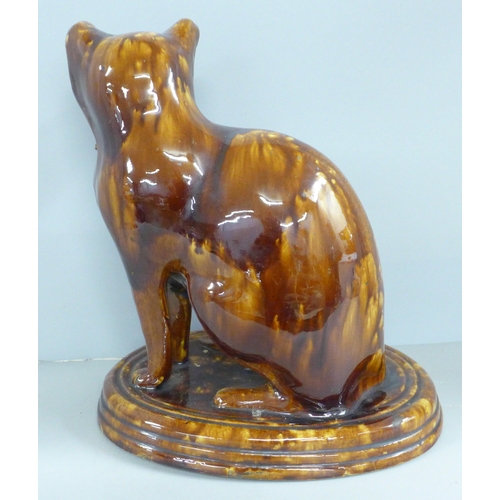 787 - A treacle glaze model of a cat, 30cm